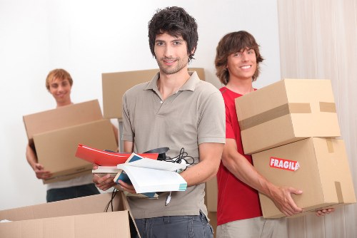 Professional office movers loading equipment for a Highbury business move