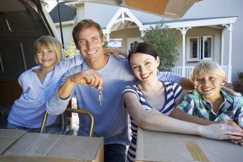 Professional movers loading household items in Highbury