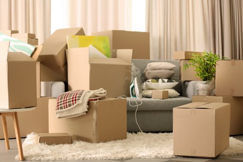Packed boxes and moving equipment prepared for a Highbury apartment removal