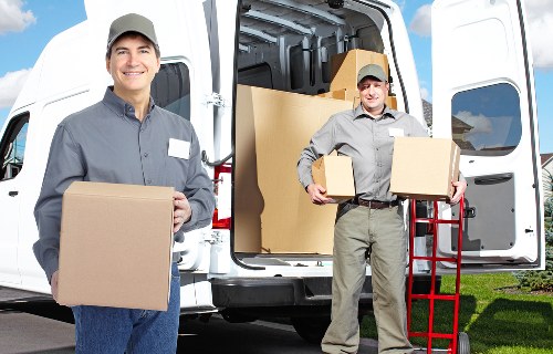 Packed moving boxes and protective wrapping prepared for a Highbury house move